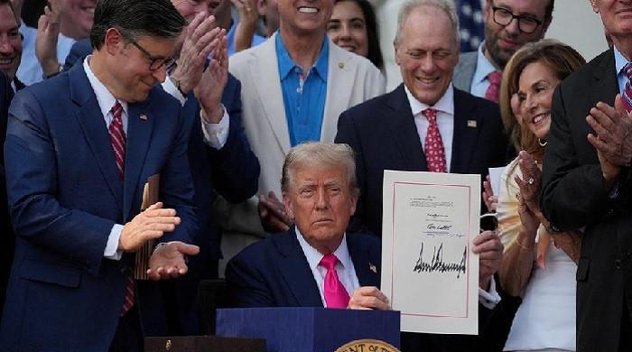 Trump signs sweeping tax cuts into law, calling it a victory for Americans